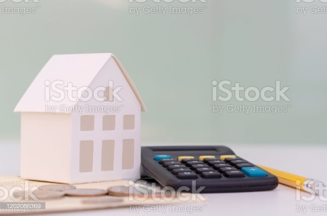 close up house's model on banking account book with calculator, coin and pencil on table for planning of home loan mortgage refinance or retention interest rates , business and financial concept